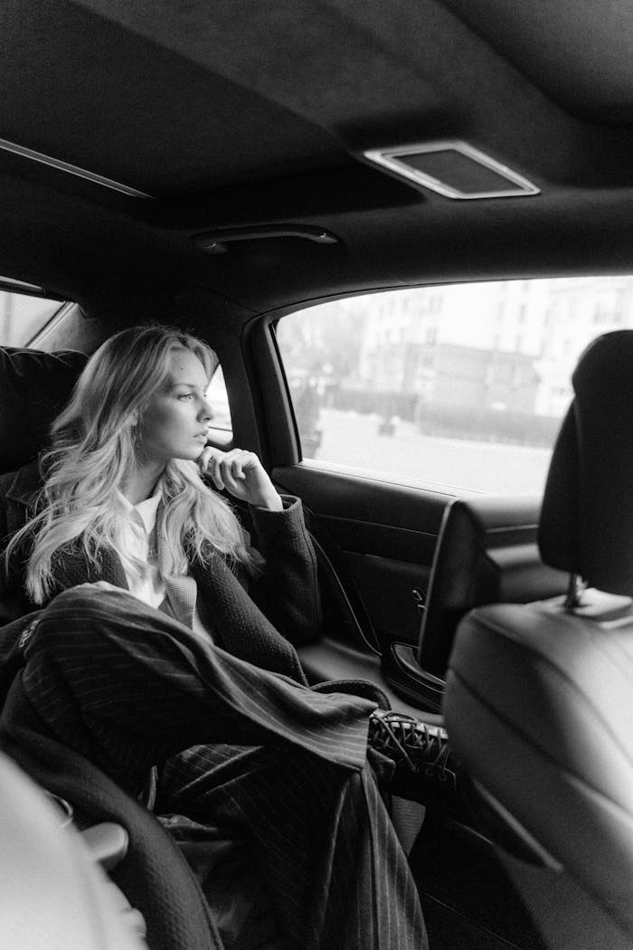 Grayscale Photo Of Woman Inside A Car